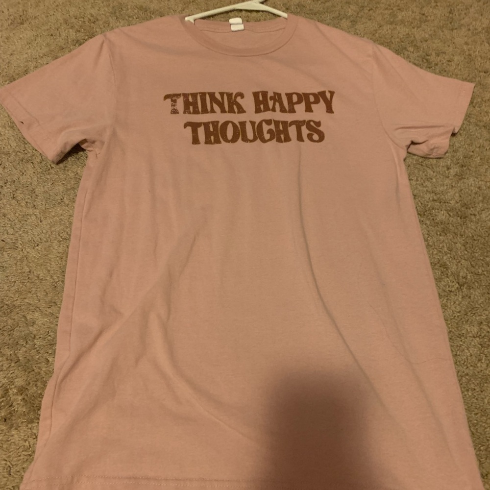 This tee shirt is pink, size medium, and a nice cotton material.
